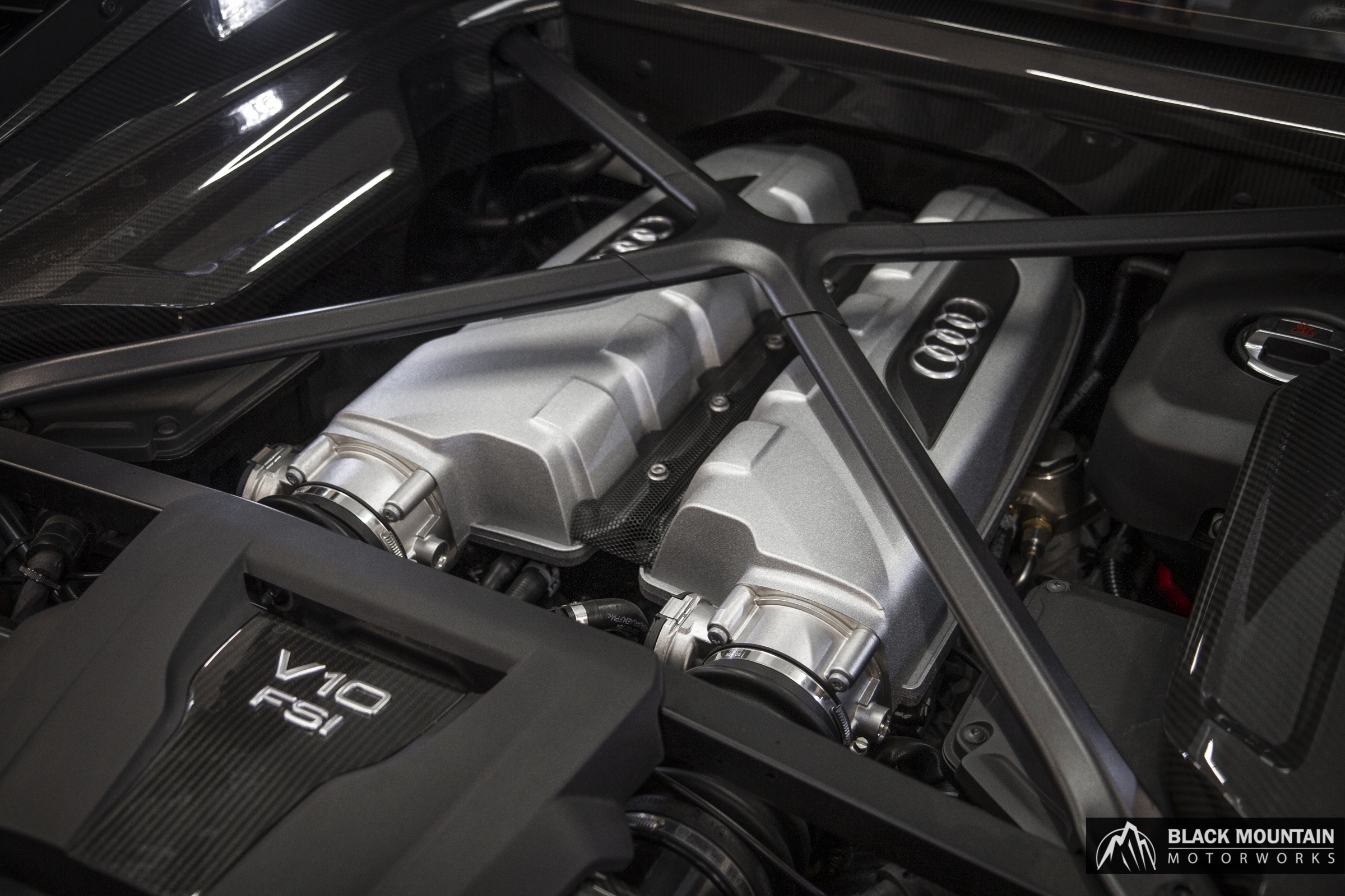 Engine bay of a high-performance vehicle being reconditioned
